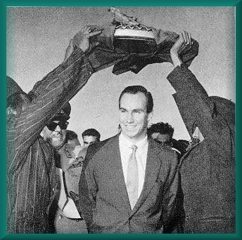 Mowlana Hazar Imam walking under the Holy Quran held by Ismailis Syria October 30, 1959